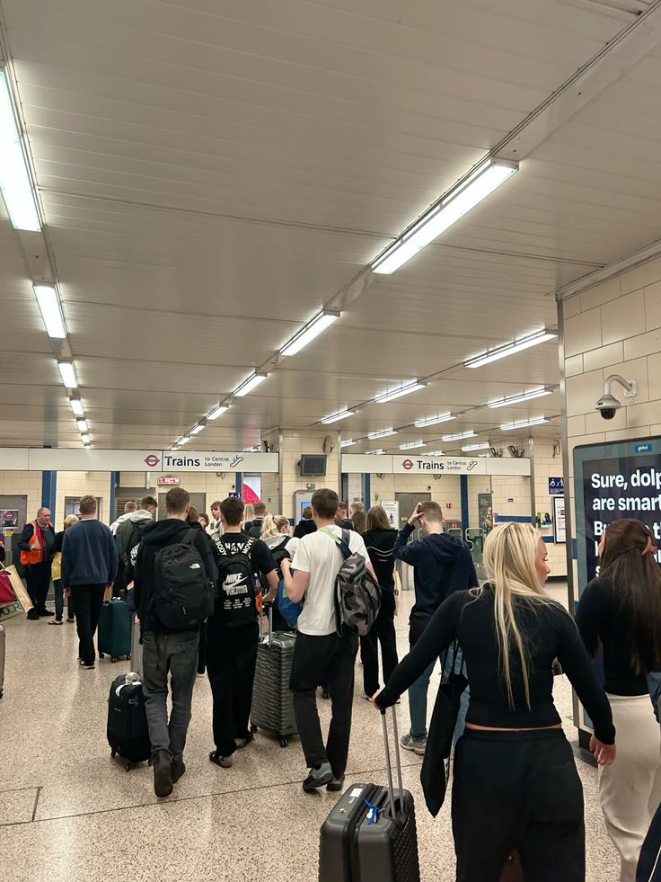 American traveler arriving at Heathrow with luggage after flight