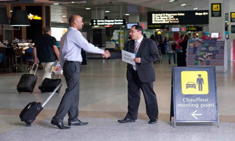 Chauffeur meeting American traveler at Heathrow Airport with a name sign